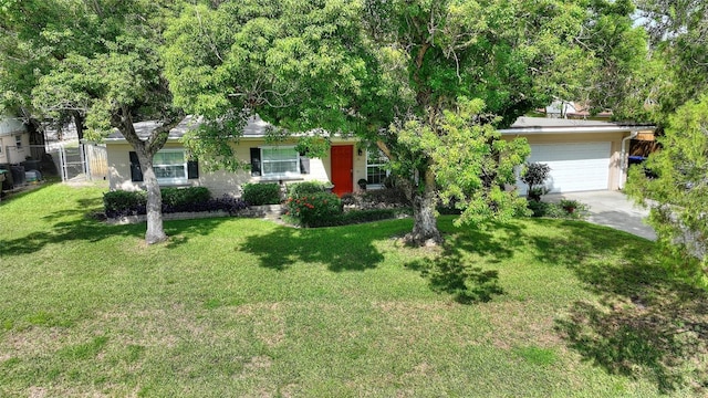 single story home featuring a garage and a front lawn