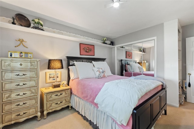 bedroom featuring a closet and light colored carpet