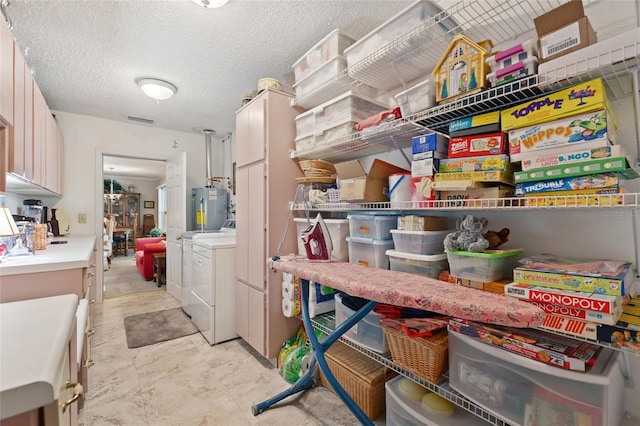 storage area with gas water heater and separate washer and dryer