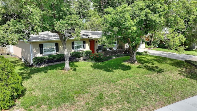 ranch-style home featuring a front yard