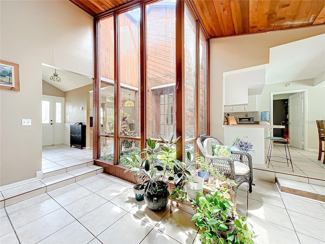 sunroom featuring lofted ceiling, french doors, wood ceiling, and a toaster