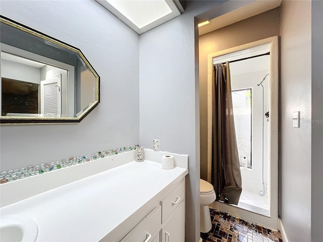 bathroom with toilet, a stall shower, brick floor, and vanity