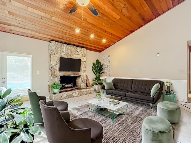 tiled living room featuring lofted ceiling, wood ceiling, a fireplace, and ceiling fan