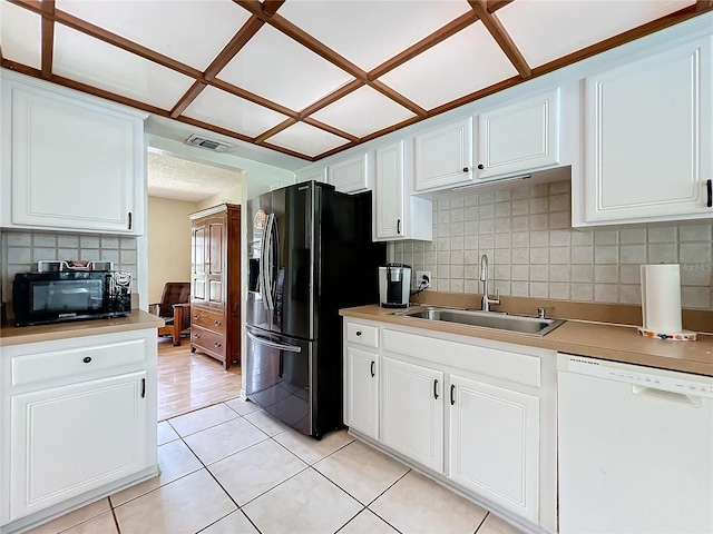 kitchen featuring visible vents, light countertops, black appliances, white cabinetry, and a sink