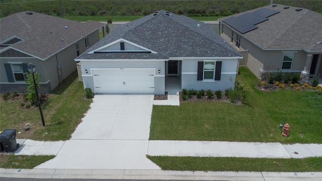 view of front of house featuring a garage and a front yard