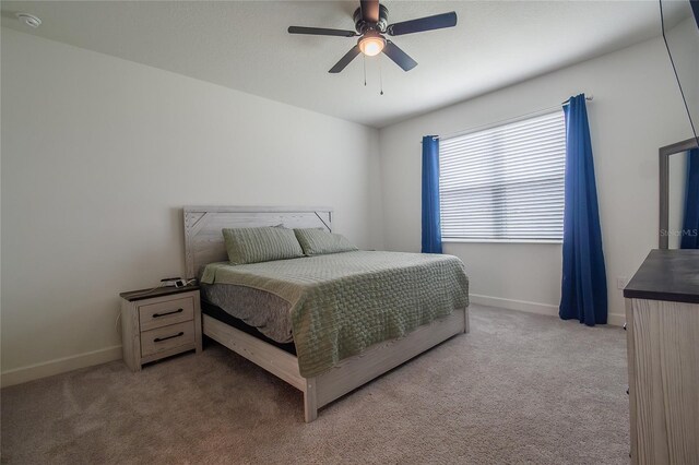 bedroom featuring ceiling fan and carpet