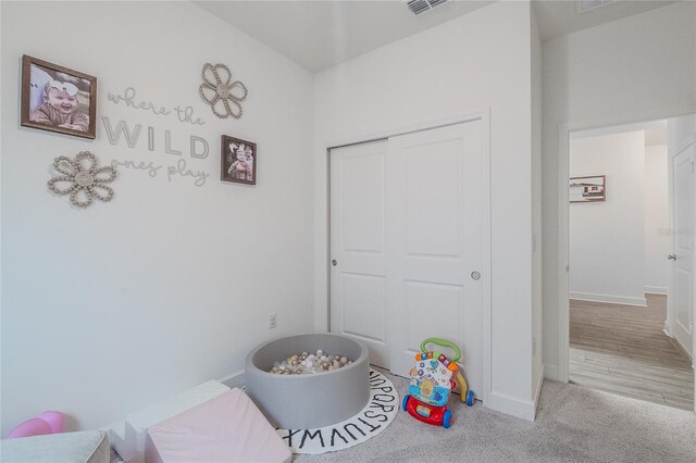 bedroom with wood-type flooring and a closet