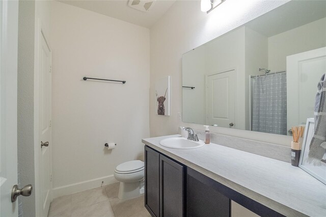 bathroom featuring toilet, tile patterned floors, and vanity