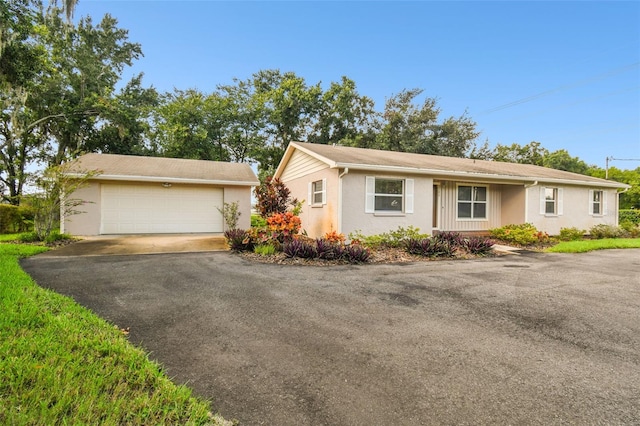 single story home with a detached garage and stucco siding