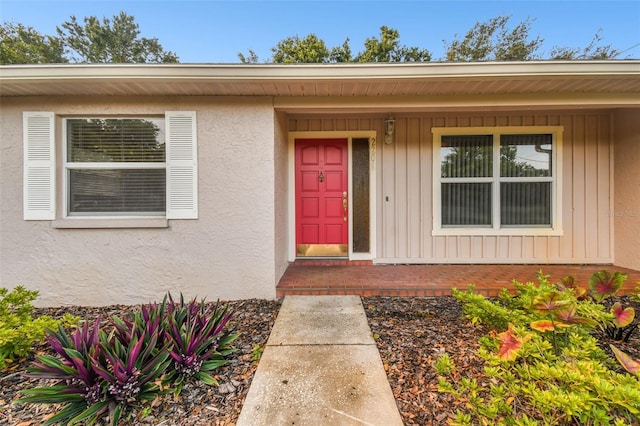 entrance to property with stucco siding