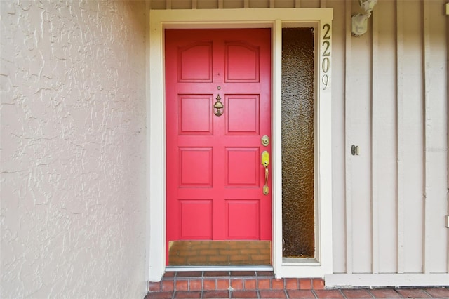 view of exterior entry with stucco siding