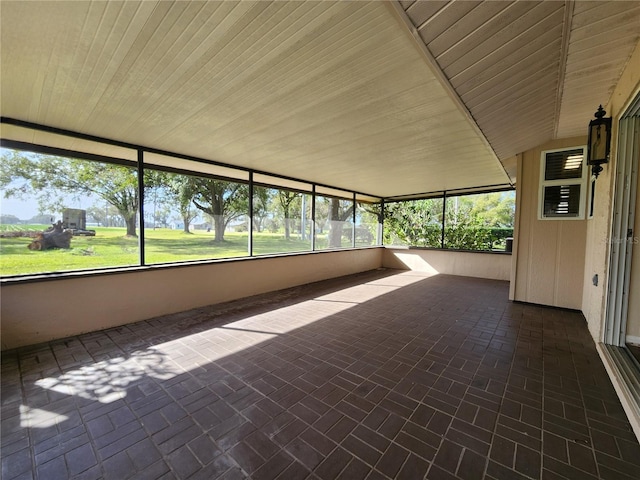 unfurnished sunroom with wood ceiling