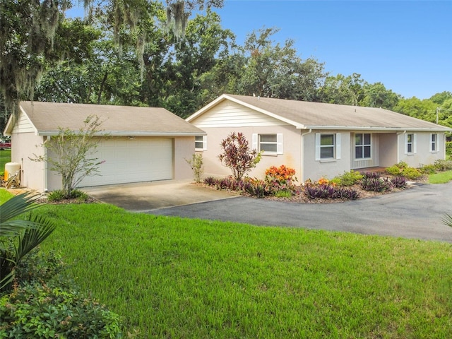 ranch-style home with driveway and a front yard