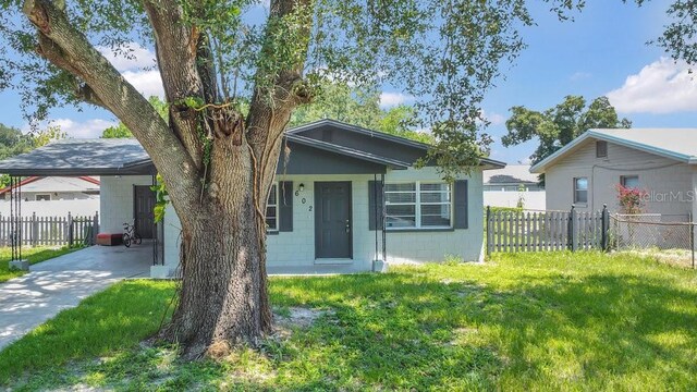 602 Taylor Blvd, Winter Haven, FL 33880 - view of front of property featuring concrete block siding, an attached carport, and concrete driveway