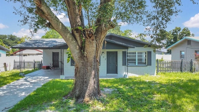 602 Taylor Blvd, Winter Haven, FL 33880 - view of front of house with concrete block siding, a carport, and concrete driveway