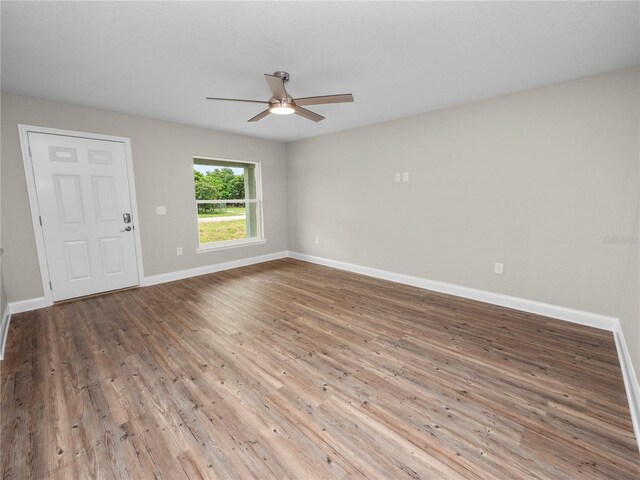 empty room featuring ceiling fan and hardwood / wood-style floors