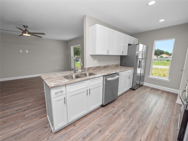 kitchen with sink, light wood-type flooring, ceiling fan, and stainless steel appliances