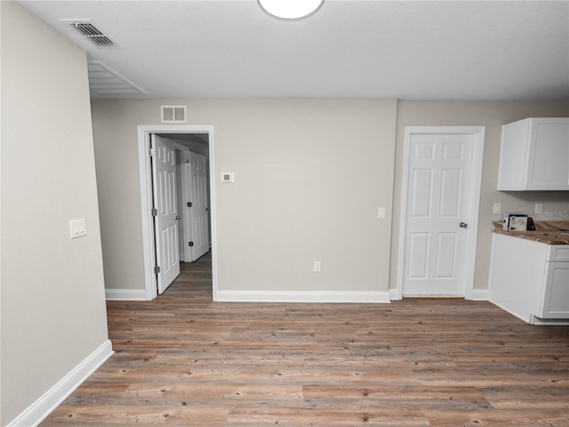 unfurnished dining area featuring hardwood / wood-style floors