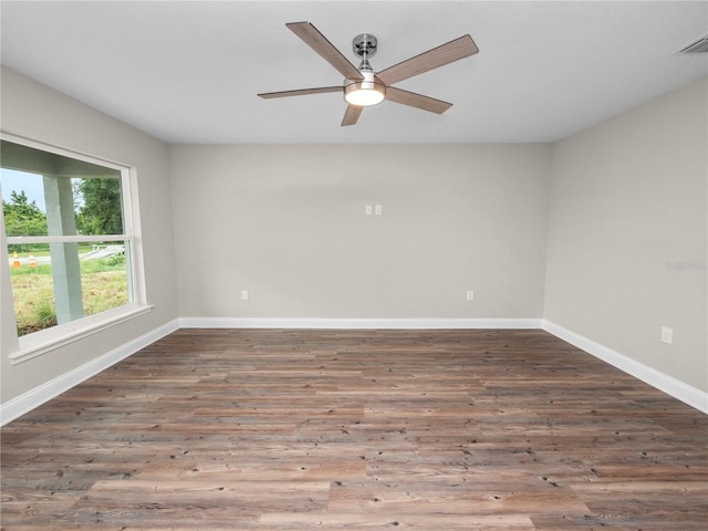 spare room with hardwood / wood-style floors and ceiling fan