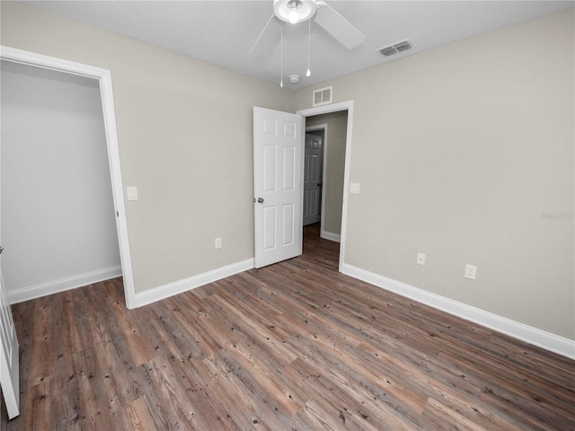 unfurnished bedroom with ceiling fan and wood-type flooring