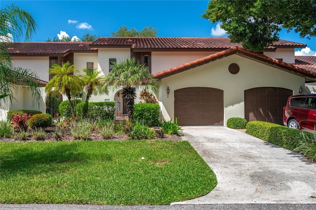 mediterranean / spanish-style house with a garage and a front yard