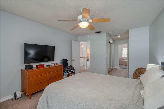 bedroom featuring light colored carpet, ensuite bath, a closet, and ceiling fan