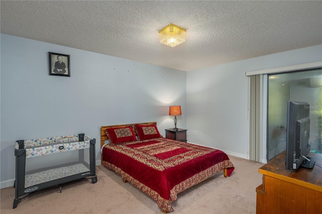 carpeted bedroom featuring a textured ceiling