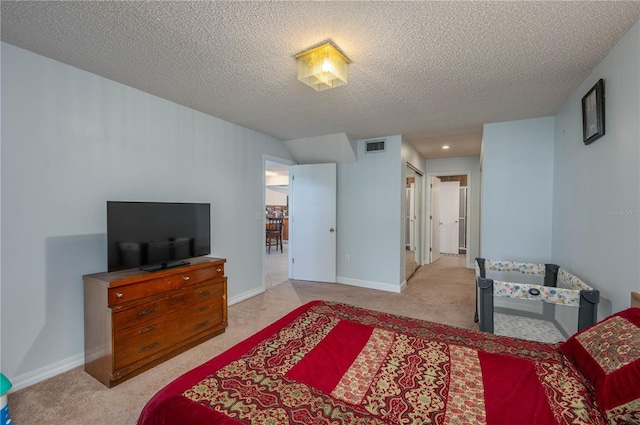 carpeted bedroom featuring a textured ceiling