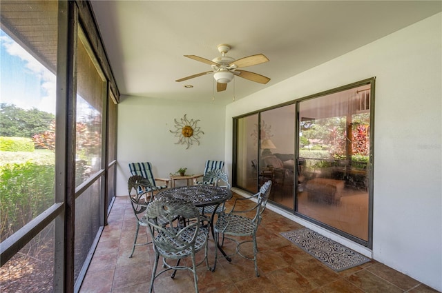 sunroom featuring a wealth of natural light and ceiling fan