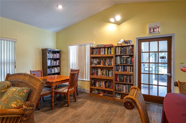 office area featuring lofted ceiling, wood-type flooring, and a textured ceiling