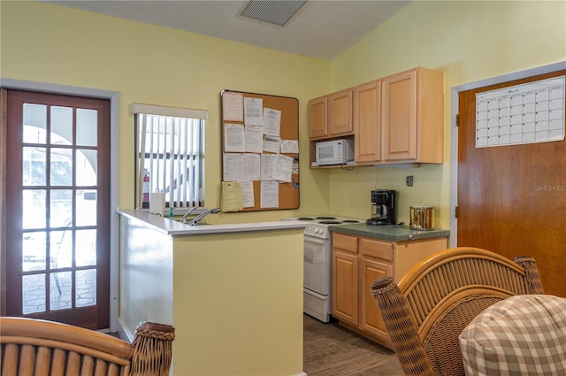 kitchen featuring a textured ceiling, vaulted ceiling, dark hardwood / wood-style floors, and white appliances