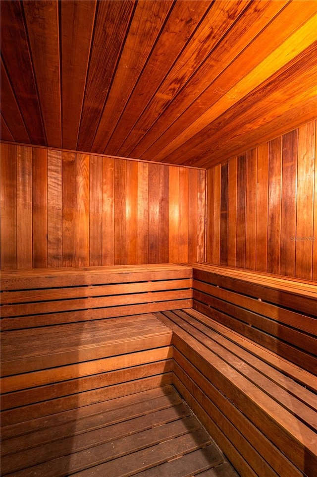 view of sauna / steam room with wood ceiling, wood walls, and wood-type flooring