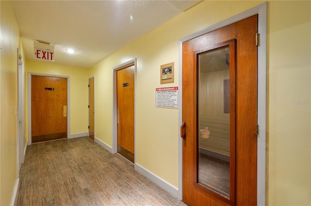 corridor with light wood-type flooring