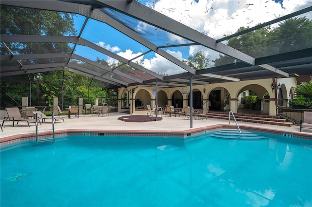 view of swimming pool with a lanai and a patio