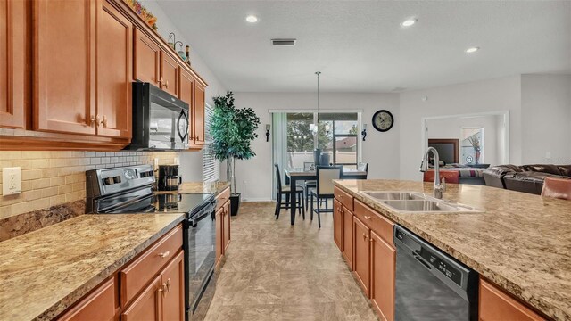 kitchen featuring hanging light fixtures, decorative backsplash, light tile patterned flooring, sink, and black appliances