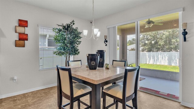 dining room featuring light tile patterned flooring and ceiling fan with notable chandelier