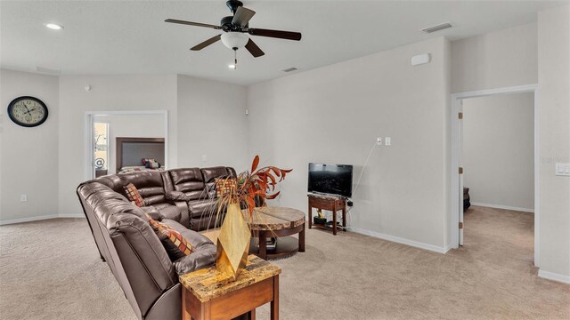 carpeted living room featuring ceiling fan