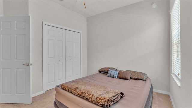 carpeted bedroom featuring a closet