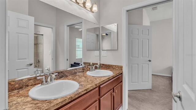 bathroom featuring tub / shower combination and double vanity