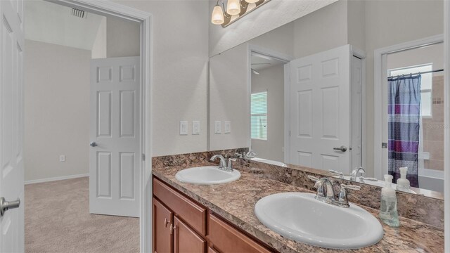 bathroom featuring double vanity