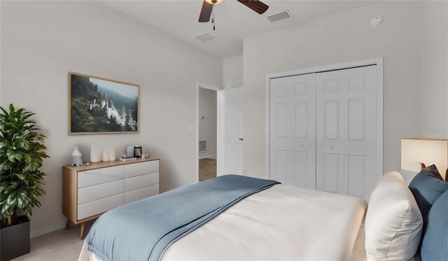 bedroom with ceiling fan, a closet, and carpet