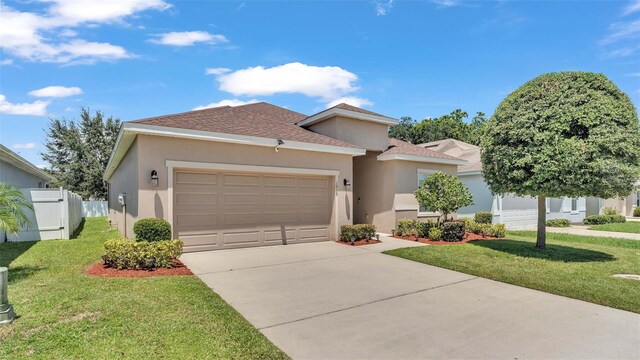 view of front of home featuring a front yard and a garage