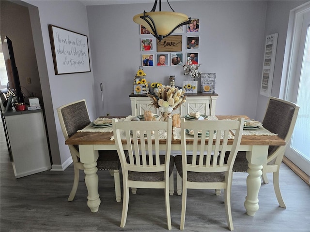 dining area featuring baseboards and wood finished floors