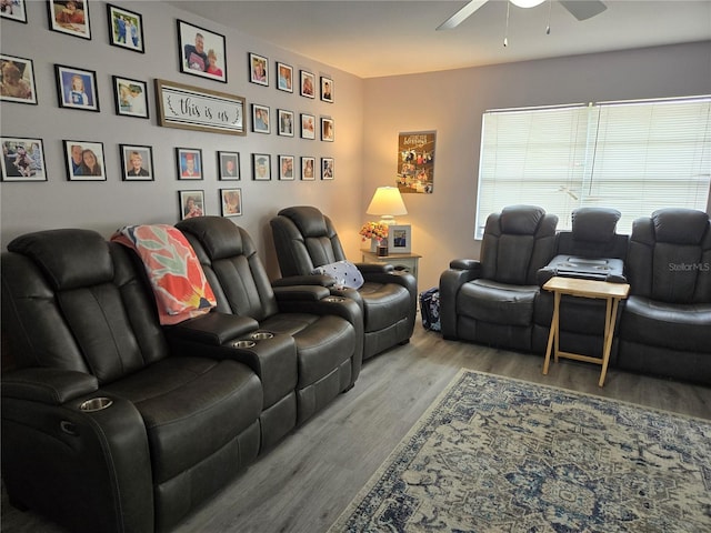 living area with wood finished floors and a ceiling fan