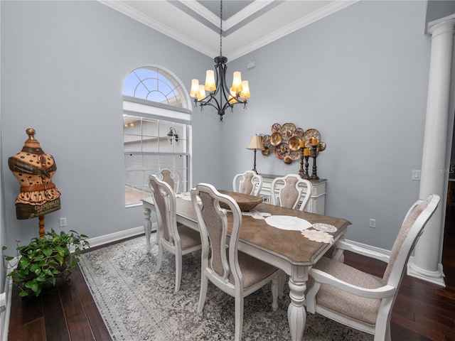 dining room featuring ornate columns, a chandelier, dark hardwood / wood-style floors, and ornamental molding