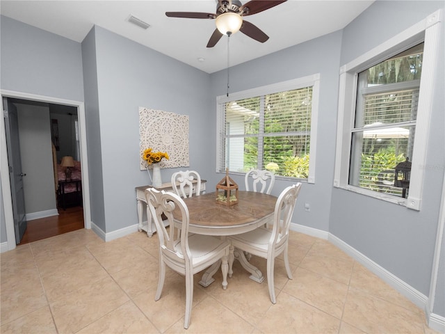 tiled dining space with ceiling fan