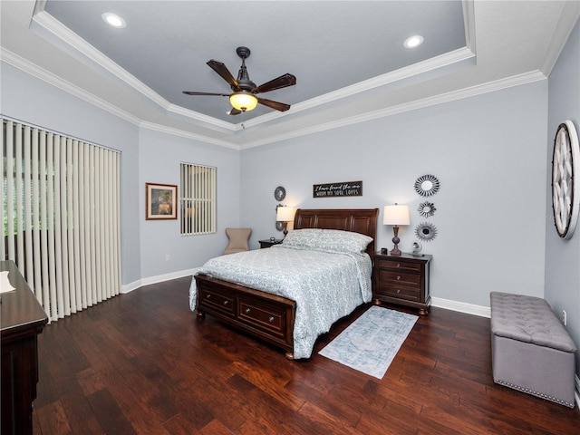 bedroom featuring a raised ceiling, ceiling fan, dark wood-type flooring, and ornamental molding