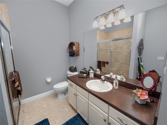 bathroom featuring tile patterned flooring, vanity, toilet, and walk in shower