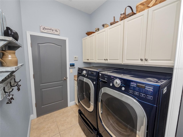 laundry area with cabinets, light tile patterned floors, and washing machine and dryer