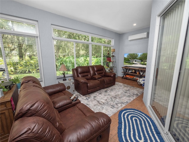 interior space with a wall mounted air conditioner and hardwood / wood-style flooring